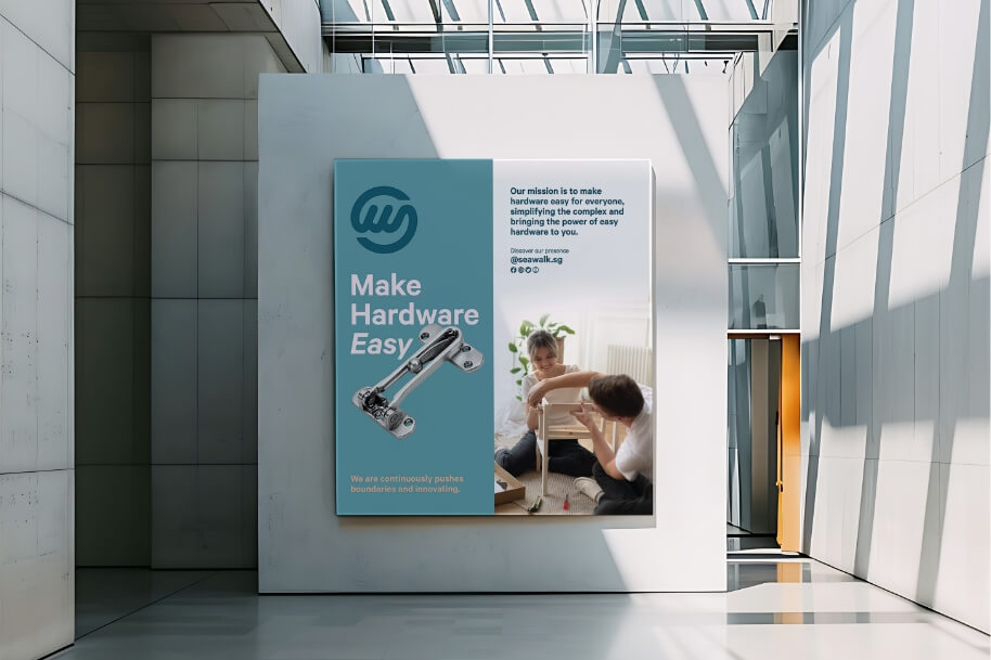 Poster on a white wall reads 'Make Hardware Easy' with a hinge illustration on a teal left panel; the right panel shows people assembling a project in a bright atrium.