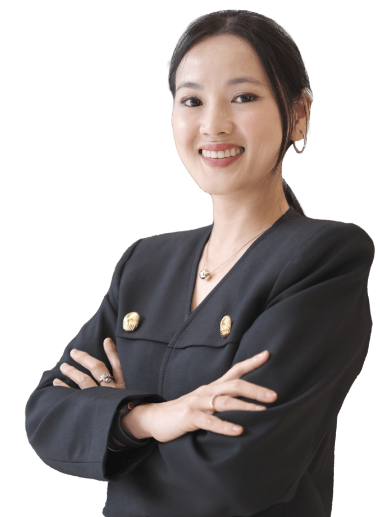 Professional woman with arms crossed, smiling, in a black blazer with gold buttons.