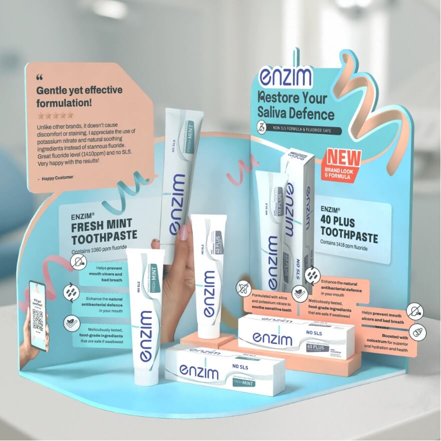Display stand featuring Enzim toothpaste and mouthcare products with mint flavor branding and a pale pink and blue color scheme.